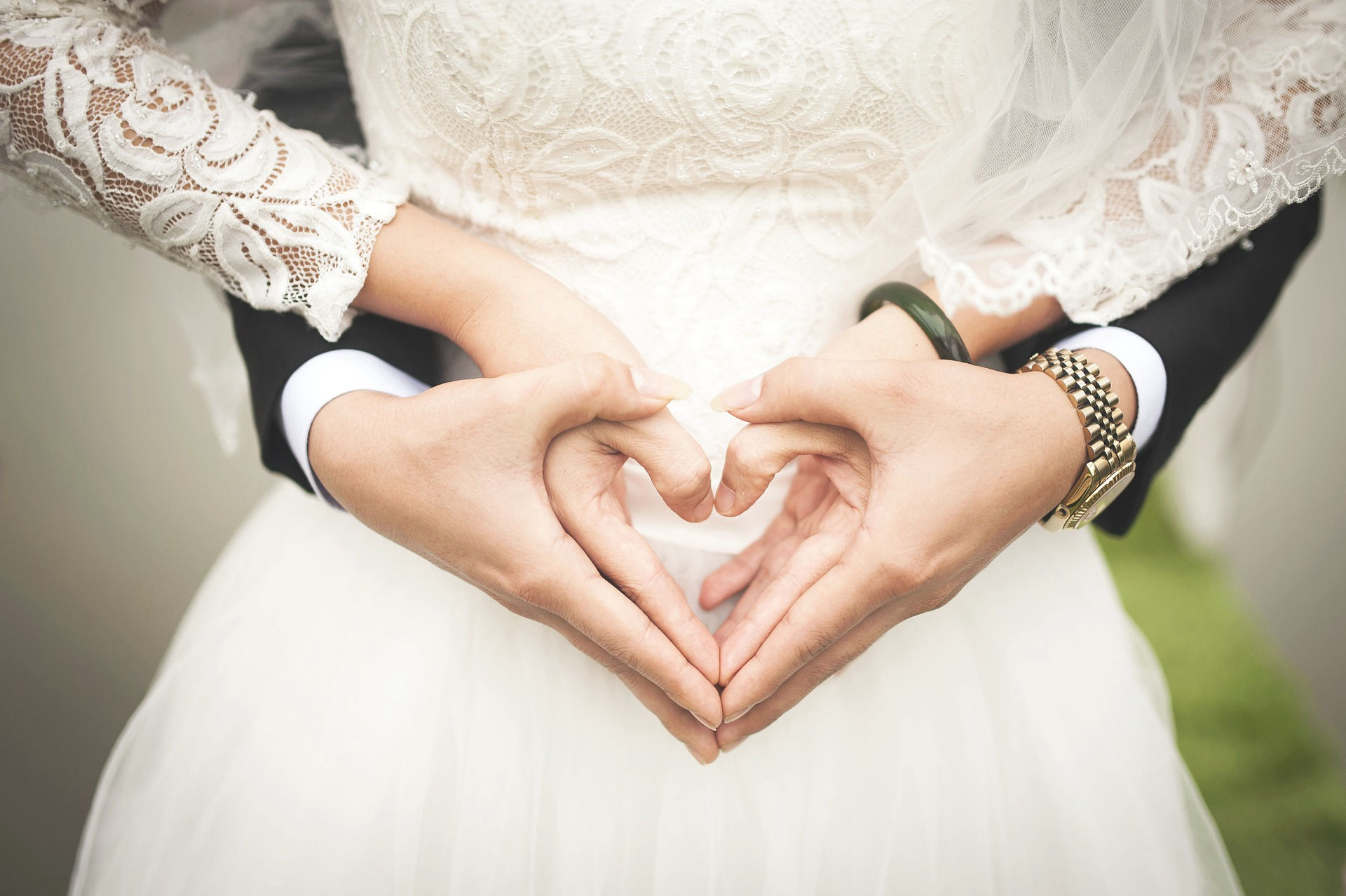 Bride and groom make a love sign taken by JPH photography